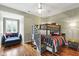 Cozy bedroom featuring a bunk bed with stairs and a sitting area by a bright window at 4725 Saratoga Falls Ln, Raleigh, NC 27614