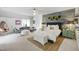 Open bedroom with cozy decor, seating area, and carpeted floors at 4725 Saratoga Falls Ln, Raleigh, NC 27614