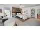 Spacious bedroom featuring accent wall, ceiling fan, and comfortable furnishings at 4725 Saratoga Falls Ln, Raleigh, NC 27614