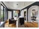Dining room boasts wood floors, a custom light fixture, built-in shelving, and views to the adjacent rooms at 4725 Saratoga Falls Ln, Raleigh, NC 27614