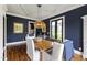 Traditional dining room features dark blue walls, hardwood floors, and a woven pendant light fixture at 4725 Saratoga Falls Ln, Raleigh, NC 27614