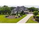 Sprawling lawn leads to this beautiful white home with a three car garage and a grand driveway at 4725 Saratoga Falls Ln, Raleigh, NC 27614