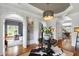 A foyer showing hardwood floors, white trim and accents, with an elegant round table centerpiece at 4725 Saratoga Falls Ln, Raleigh, NC 27614