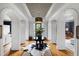 Grand foyer with a patterned ceiling, hardwood floors, and an elegant round table centerpiece at 4725 Saratoga Falls Ln, Raleigh, NC 27614