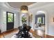 Elegant foyer featuring a round table, hardwood floors, and large windows allowing natural light at 4725 Saratoga Falls Ln, Raleigh, NC 27614