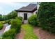 Inviting home entrance with manicured landscaping, stone steps, and stylish black double doors at 4725 Saratoga Falls Ln, Raleigh, NC 27614