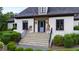 Elegant front entrance with stone steps, landscaped bushes, and a powder blue front door at 4725 Saratoga Falls Ln, Raleigh, NC 27614