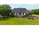 Beautifully landscaped front yard with lush green grass, manicured bushes and mature trees at 4725 Saratoga Falls Ln, Raleigh, NC 27614