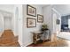 Hallway with hardwood floors leads to a living room and features a cozy writing desk with a comfy seat at 4725 Saratoga Falls Ln, Raleigh, NC 27614