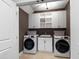 Well-organized laundry room with modern washer and dryer units plus storage at 4725 Saratoga Falls Ln, Raleigh, NC 27614