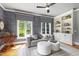 Cozy living room featuring built-in shelving, natural lighting, a stylish couch, and two ottomans at 4725 Saratoga Falls Ln, Raleigh, NC 27614