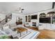Cozy living room with hardwood floors, fireplace, built-ins, and a large sectional sofa at 4725 Saratoga Falls Ln, Raleigh, NC 27614