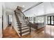 Inviting living room with hardwood floors, staircase, and access to the backyard at 4725 Saratoga Falls Ln, Raleigh, NC 27614