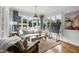 Sunlit living room with large windows and backyard view, featuring comfortable seating and stylish decor at 4725 Saratoga Falls Ln, Raleigh, NC 27614