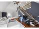 Open-concept living room with hardwood floors and a staircase at 4725 Saratoga Falls Ln, Raleigh, NC 27614