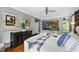 Serene main bedroom featuring hardwood floors, elegant decor, and comfortable furniture, creating a relaxing retreat at 4725 Saratoga Falls Ln, Raleigh, NC 27614