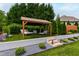 Relax in the covered pergola with lounge chairs overlooking a manicured backyard and inground pool at 4725 Saratoga Falls Ln, Raleigh, NC 27614