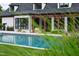Enjoy backyard views of an inground pool framed by lush greenery through ornamental grasses at 4725 Saratoga Falls Ln, Raleigh, NC 27614
