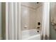 Close up of a shower tub combo featuring stylish tile accents and bronze fixtures at 4725 Saratoga Falls Ln, Raleigh, NC 27614