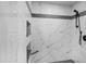 Modern shower with white tile, decorative accents, and built-in shelving niches at 4725 Saratoga Falls Ln, Raleigh, NC 27614