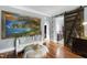 Sitting room with a large coastal painting and sliding barn door leading to the main bathroom at 4725 Saratoga Falls Ln, Raleigh, NC 27614