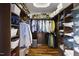 Custom closet with ample storage, built-in shelving, and hardwood flooring at 4725 Saratoga Falls Ln, Raleigh, NC 27614