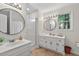 Well-lit bathroom with double vanities, modern fixtures, and a walk-in shower at 4816 Marlborough Way, Durham, NC 27713