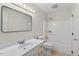 Bright bathroom featuring a single sink vanity, large mirror, and a shower-tub combination with white tiling at 4816 Marlborough Way, Durham, NC 27713