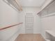Walk-in closet featuring carpeted floors, shelving on all sides, and open storage perfect for clothing at 4816 Marlborough Way, Durham, NC 27713