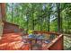 Spacious deck features outdoor furniture perfect for enjoying the private wooded backyard at 4816 Marlborough Way, Durham, NC 27713