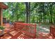 Large outdoor deck with outdoor seating overlooking a private backyard surrounded by trees at 4816 Marlborough Way, Durham, NC 27713