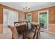 Elegant dining room with warm wallpaper and direct access to the kitchen at 4816 Marlborough Way, Durham, NC 27713