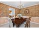 Formal dining room featuring stylish wallpaper and a classic chandelier at 4816 Marlborough Way, Durham, NC 27713
