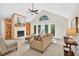 Bright living room with vaulted ceilings, fireplace, and access to the deck at 4816 Marlborough Way, Durham, NC 27713