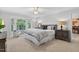 Serene main bedroom showcasing a large window, neutral tones, and comfortable furnishings at 4816 Marlborough Way, Durham, NC 27713