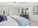 Comfortable bedroom featuring a window, soft bedding, and easy access to the bathroom at 4816 Marlborough Way, Durham, NC 27713