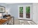 Bright home office with double doors leading to a deck and a view of the wooded backyard at 4816 Marlborough Way, Durham, NC 27713