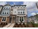 Charming townhome exterior featuring a combination of stone and siding, with a welcoming front entrance at 5031 Se Jowetts Walk Dr # 28, Cary, NC 27519