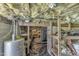 View of the unfinished basement with vapor barrier, insulation, and shelves at 52 Malcolm Dr, Clayton, NC 27520