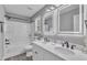 Modern bathroom with dual sinks, bright mirrors, and shower-tub combination at 52 Malcolm Dr, Clayton, NC 27520
