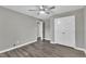 A clean, gray bedroom features gray wood flooring and a ceiling fan at 52 Malcolm Dr, Clayton, NC 27520