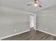 Comfortable bedroom with neutral paint, wood flooring, and ceiling fan at 52 Malcolm Dr, Clayton, NC 27520