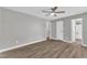 Cozy bedroom with wood flooring, neutral paint, and accessible ensuite bathroom at 52 Malcolm Dr, Clayton, NC 27520