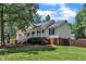 Inviting home with a covered front porch, surrounded by lush greenery and a well-kept lawn at 52 Malcolm Dr, Clayton, NC 27520