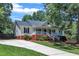 Attractive home with a covered porch, set on a well-maintained lot with a paved driveway at 52 Malcolm Dr, Clayton, NC 27520