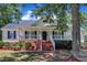 Charming single-Gathering home featuring a covered front porch with brick stairs and neatly landscaped surroundings at 52 Malcolm Dr, Clayton, NC 27520