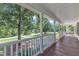 Spacious covered front porch offers a serene outdoor living space with views of the surrounding greenery at 52 Malcolm Dr, Clayton, NC 27520