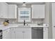 The kitchen is equipped with stainless steel appliances, white cabinets, and modern sink at 52 Malcolm Dr, Clayton, NC 27520
