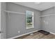 Laundry room with built-in shelves, a window with blinds and durable wood-look floors at 52 Malcolm Dr, Clayton, NC 27520
