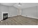 Spacious living room with luxury vinyl plank flooring, neutral walls, and a cozy fireplace at 52 Malcolm Dr, Clayton, NC 27520